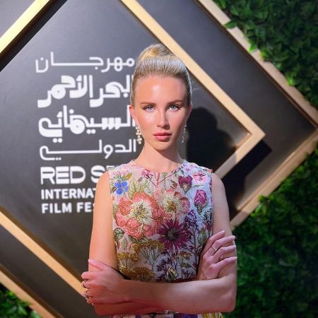 She wears one piece, earrings.